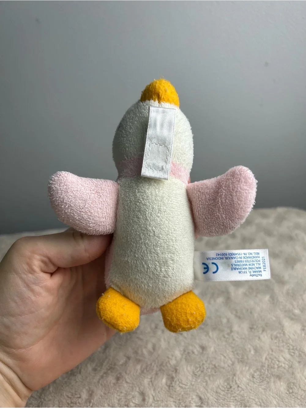 RaZbuddy Pink Penguin Plush Pacifier Holder White Orange RaZbaby Lovey